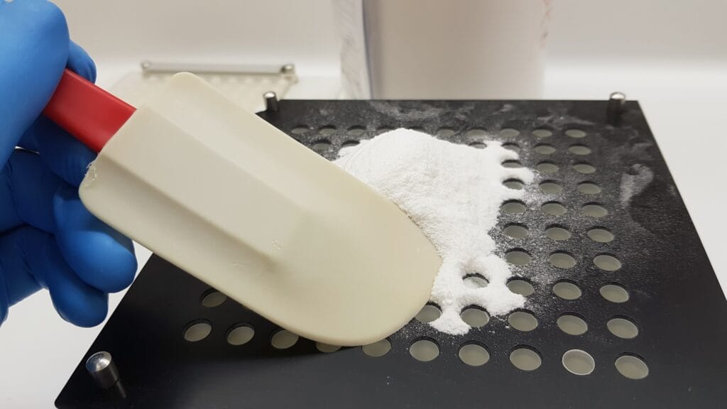 Scientist making capsules with powder medicine in the pharmacy laboratory